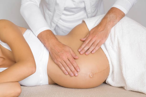 Relaxing Prenatal Massage: Skilled Therapist Providing Soothing Care for Pregnant Woman's Baby Bump