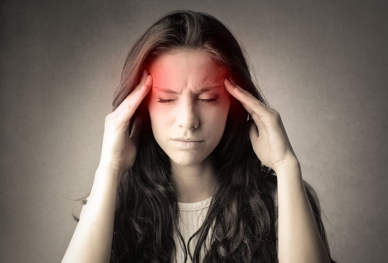 Woman experiencing intense pain and a severe headache.