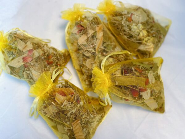 A mesh bag filled with herbal blend for a refreshing summer foot bath.