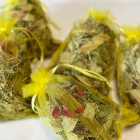 A mesh bag filled with herbal blend for winter foot baths.