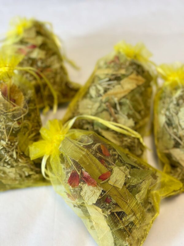 A mesh bag filled with herbal blend for winter foot baths.