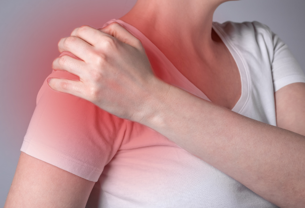 Woman in pain holding her right frozen shoulder - concept of discomfort and physical strain.